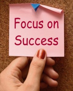 sticky note says focus on success
