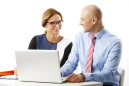 woman and man in business clothes chatting